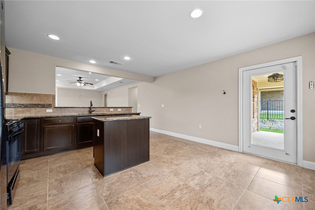 309 Kickapoo Creek Lane Georgetown, TX 78633 - Photo 14 of 28 a kitchen with a sink and a stove top oven
