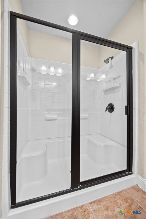309 Kickapoo Creek Lane Georgetown, TX 78633 - Photo 18 of 28 a bathroom with a glass shower door