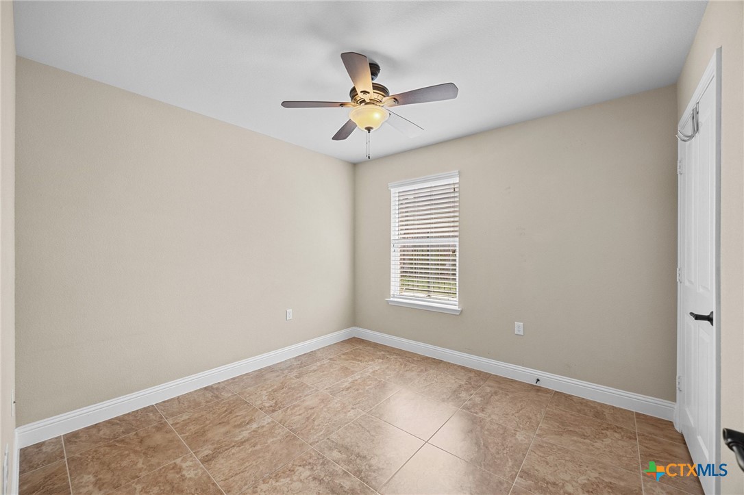 309 Kickapoo Creek Lane Georgetown, TX 78633 - Photo 22 of 28 a view of a livingroom with a ceiling fan and window