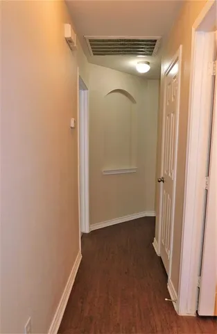 an empty room with wooden floor and a window