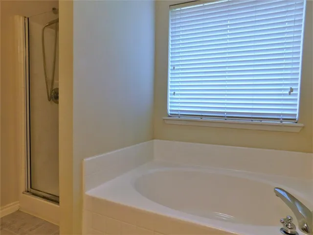 a white bath tub sitting next to a window