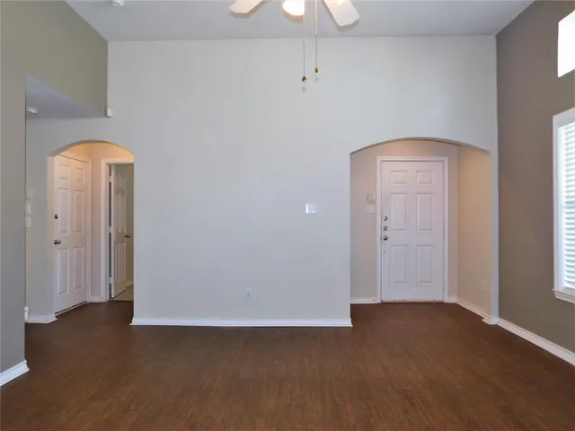 an empty room with wooden floor and closet