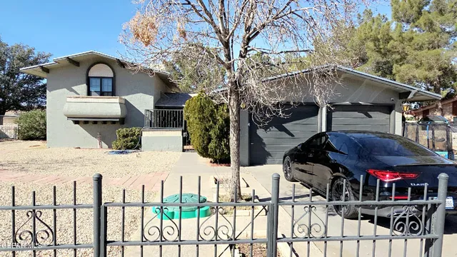 a view of a house with wooden walls and a wooden fence