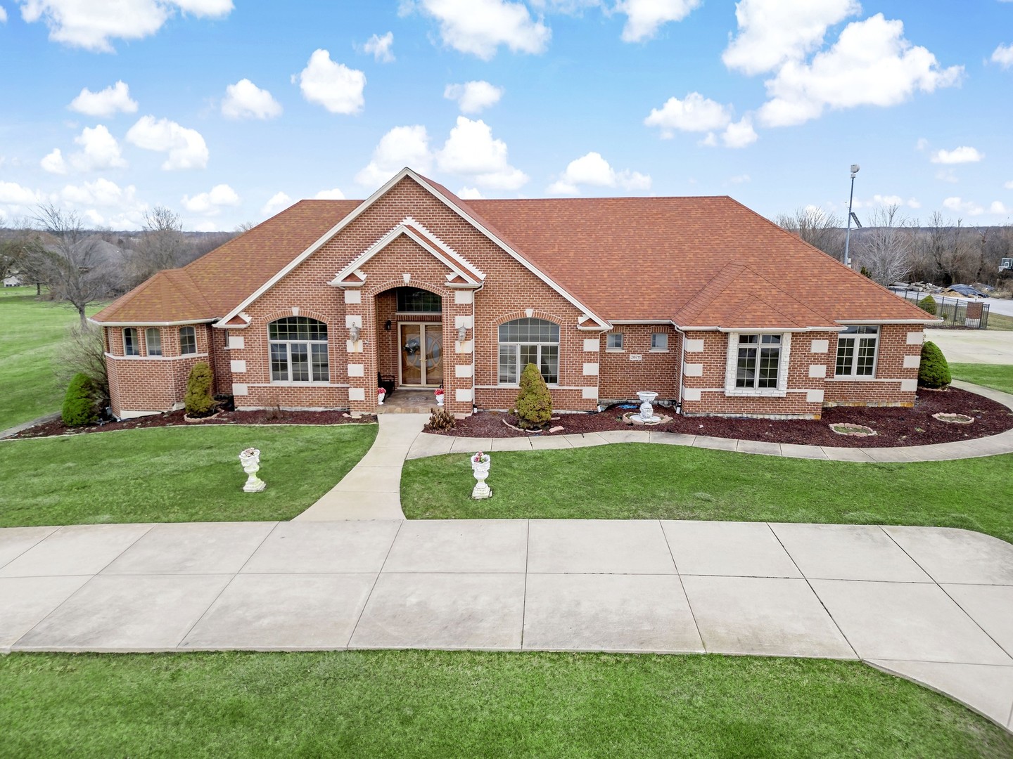 26711 South Anna Lane Monee, IL 60449 - Photo 1 of 43 a front view of a house with a garden and trees