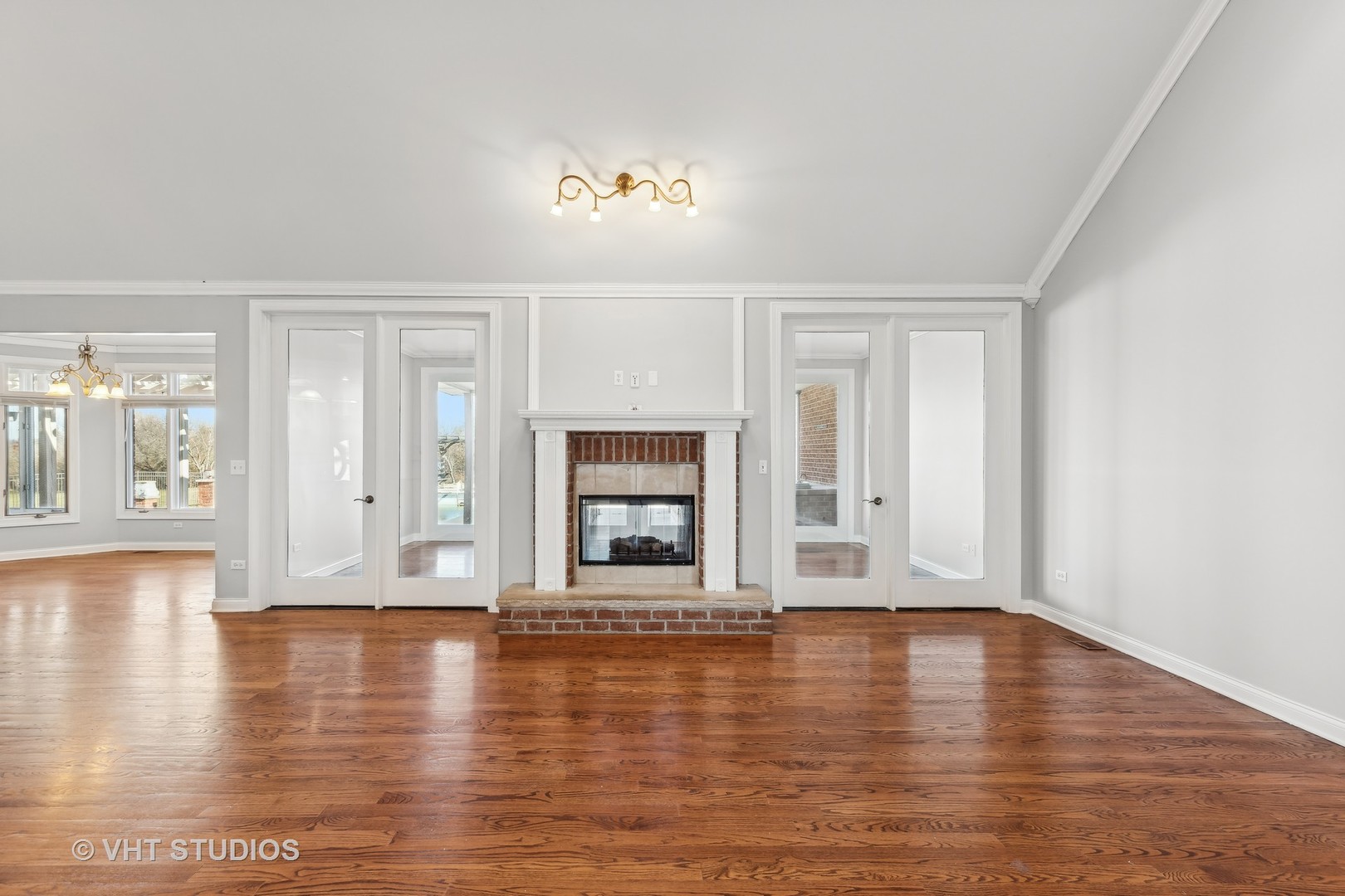 26711 South Anna Lane Monee, IL 60449 - Photo 15 of 43 a view of empty room with wooden floor and fireplace