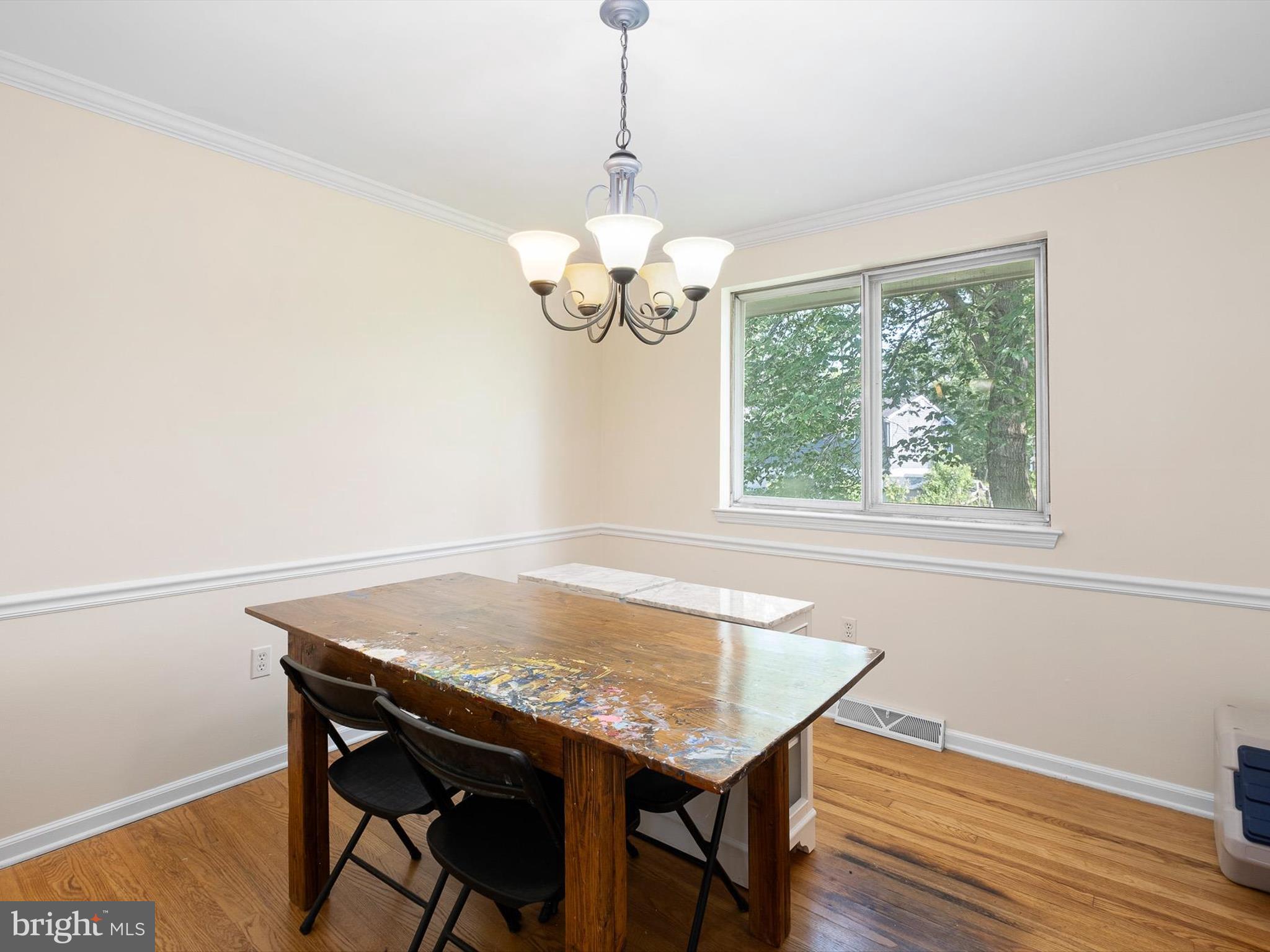 508 Garrick Road Hockessin, DE 19707 - Photo 7 of 25 a dining room with wooden floor a chandelier a wooden table and chairs