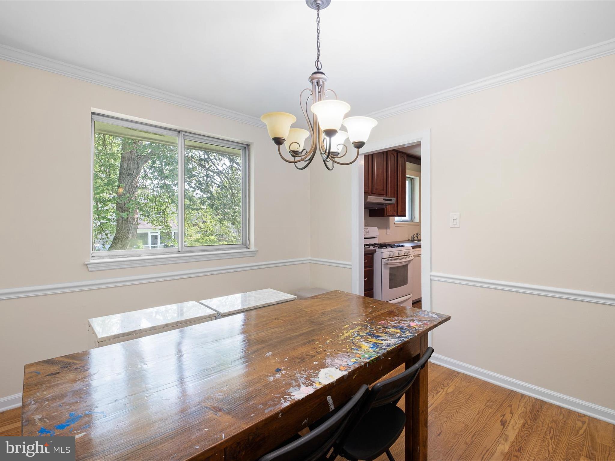 508 Garrick Road Hockessin, DE 19707 - Photo 8 of 25 a view of a kitchen with a stove wooden floor a chandelier