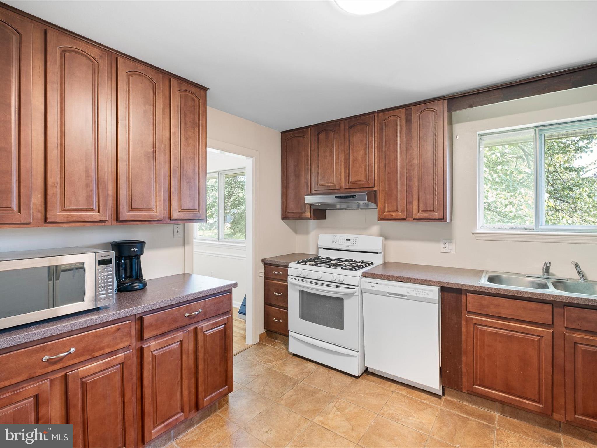 508 Garrick Road Hockessin, DE 19707 - Photo 9 of 25 a kitchen with stainless steel appliances granite countertop a sink dishwasher stove and cabinets