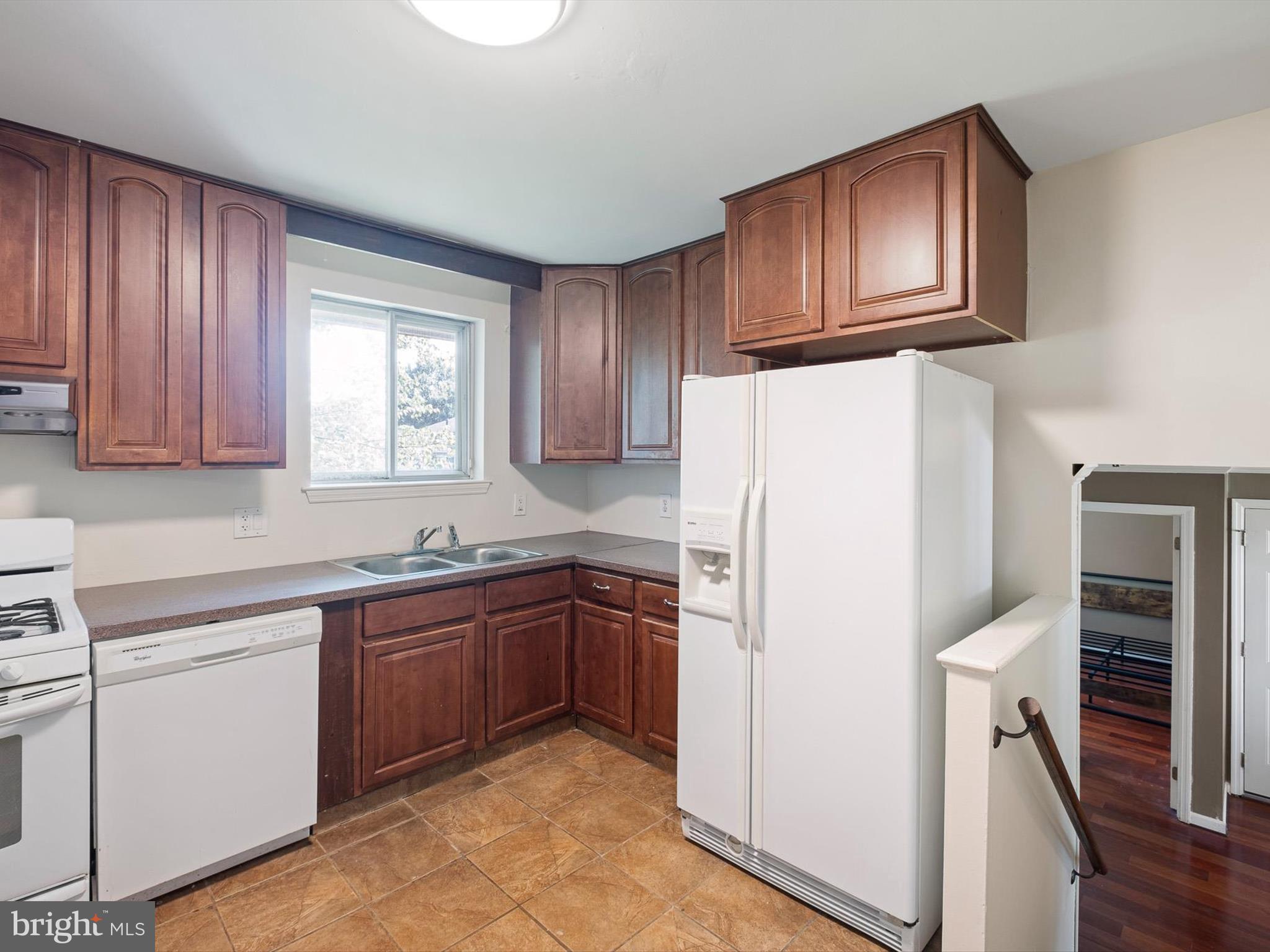 508 Garrick Road Hockessin, DE 19707 - Photo 10 of 25 a kitchen with a refrigerator sink and cabinets