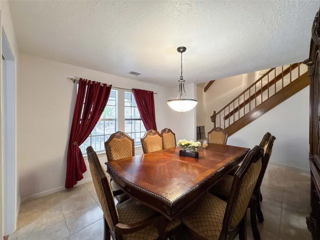 a kitchen with white cabinets and sink