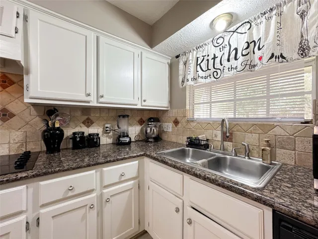 a kitchen with a sink and cabinets