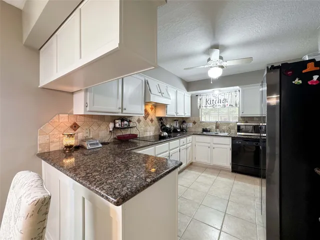 a kitchen with a dining table cabinets and window