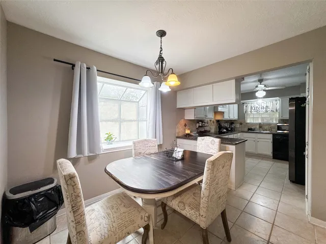 a kitchen with granite countertop a sink cabinets and appliances