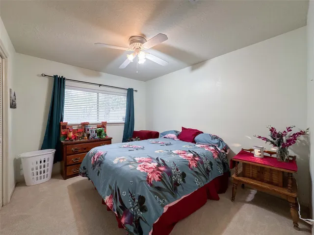 a bathroom with a granite countertop sink and a large mirror
