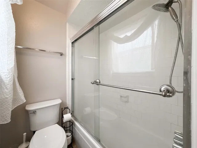 a spacious bedroom with a bed and a mirror