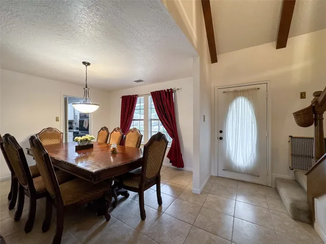 a view of a dining room a table and chairs