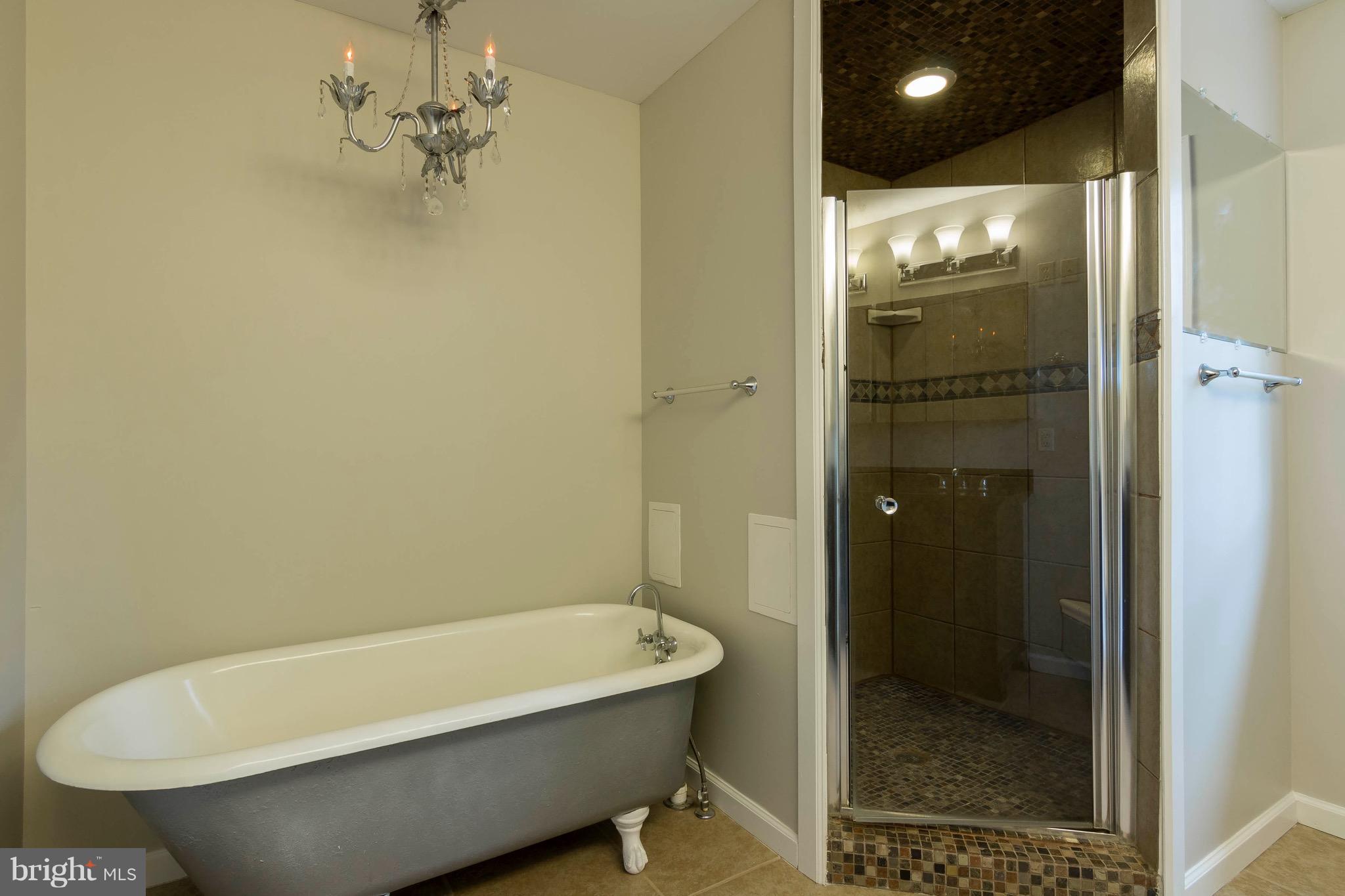 5901 Shady Spring Avenue Baltimore, MD 21237 - Photo 19 of 30 a bathroom with a bathtub and shower