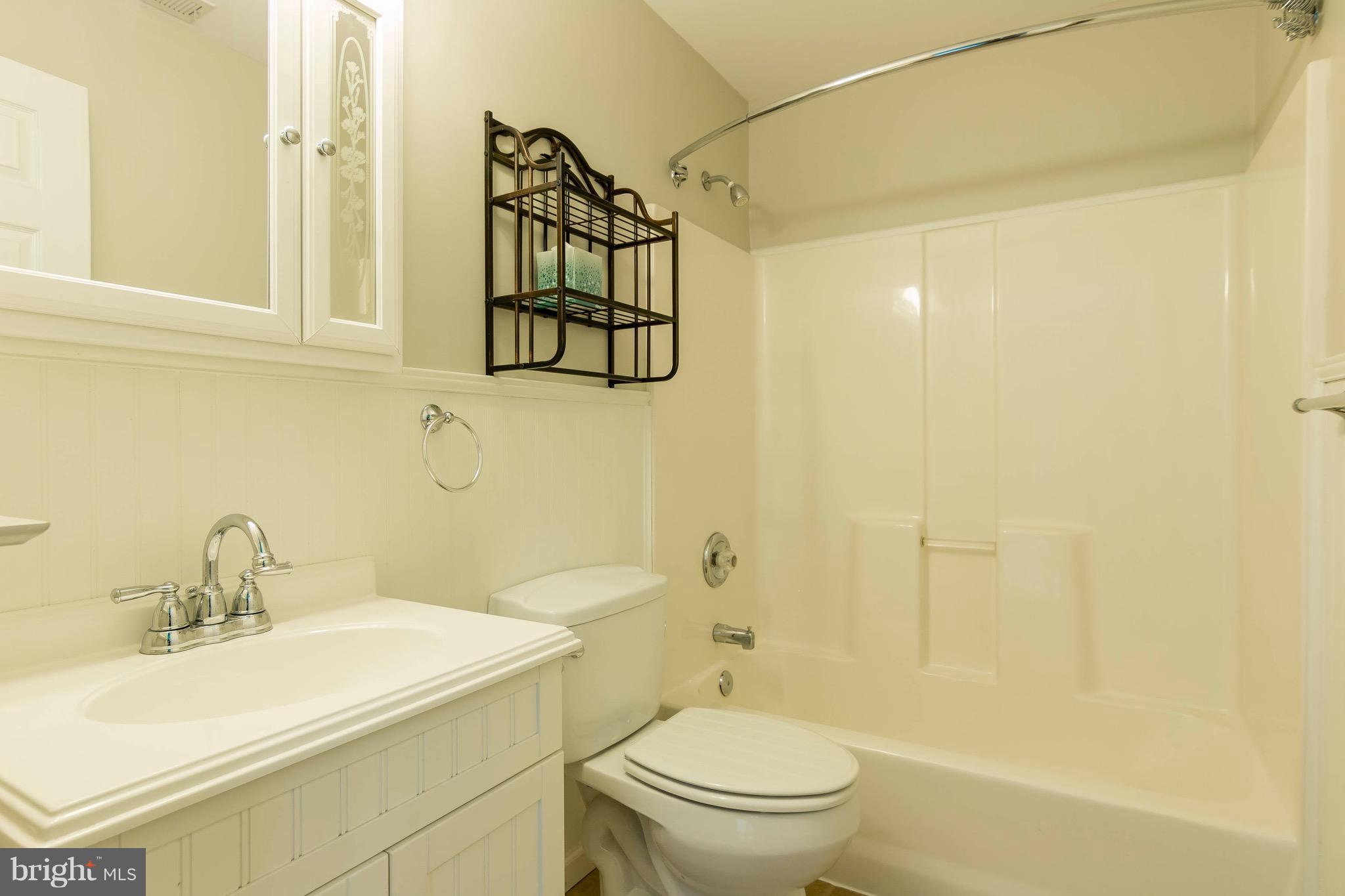 5901 Shady Spring Avenue Baltimore, MD 21237 - Photo 22 of 30 a bathroom with a sink a toilet and shower