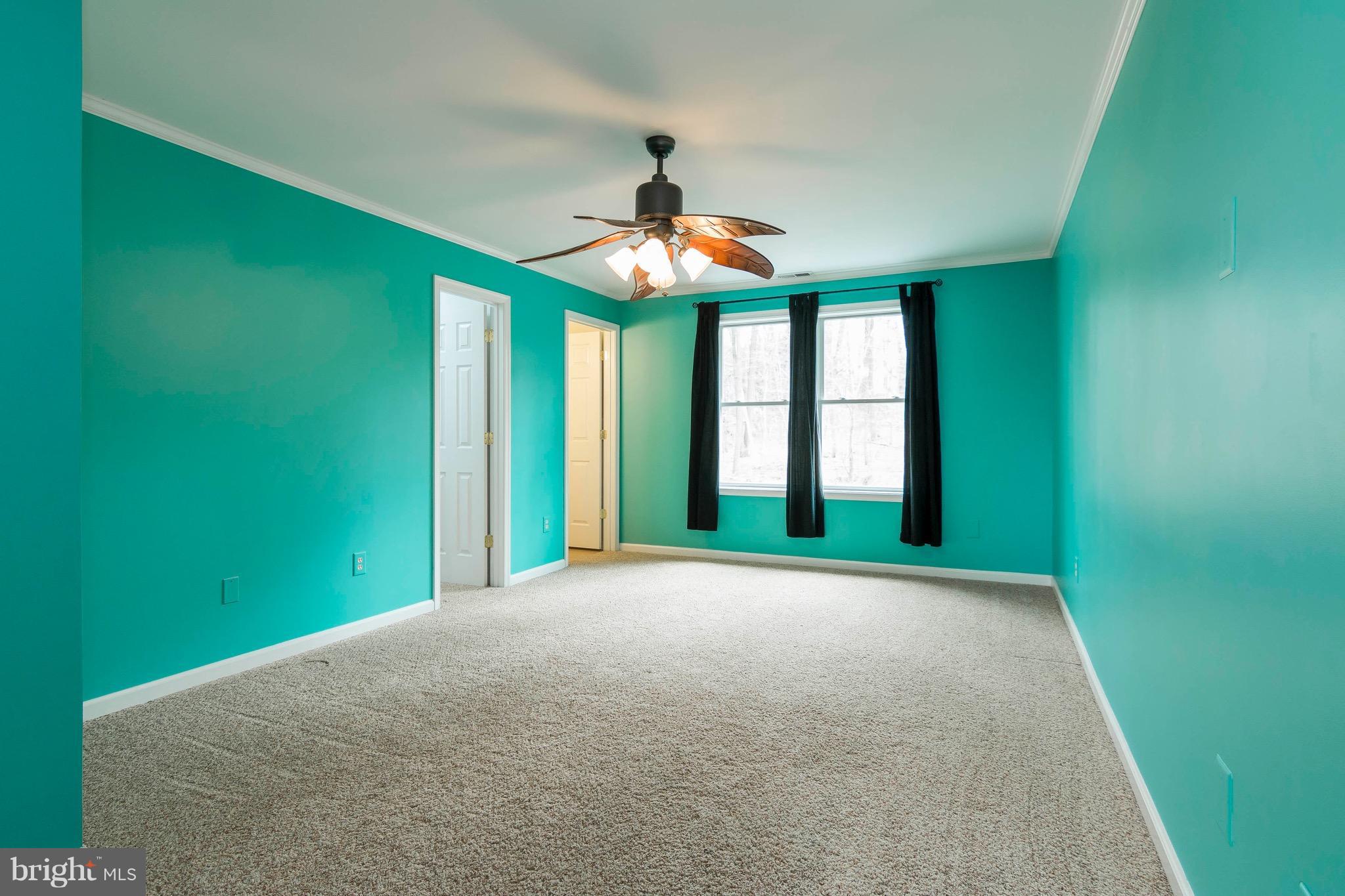 5901 Shady Spring Avenue Baltimore, MD 21237 - Photo 23 of 30 a view of an empty room with window and fan