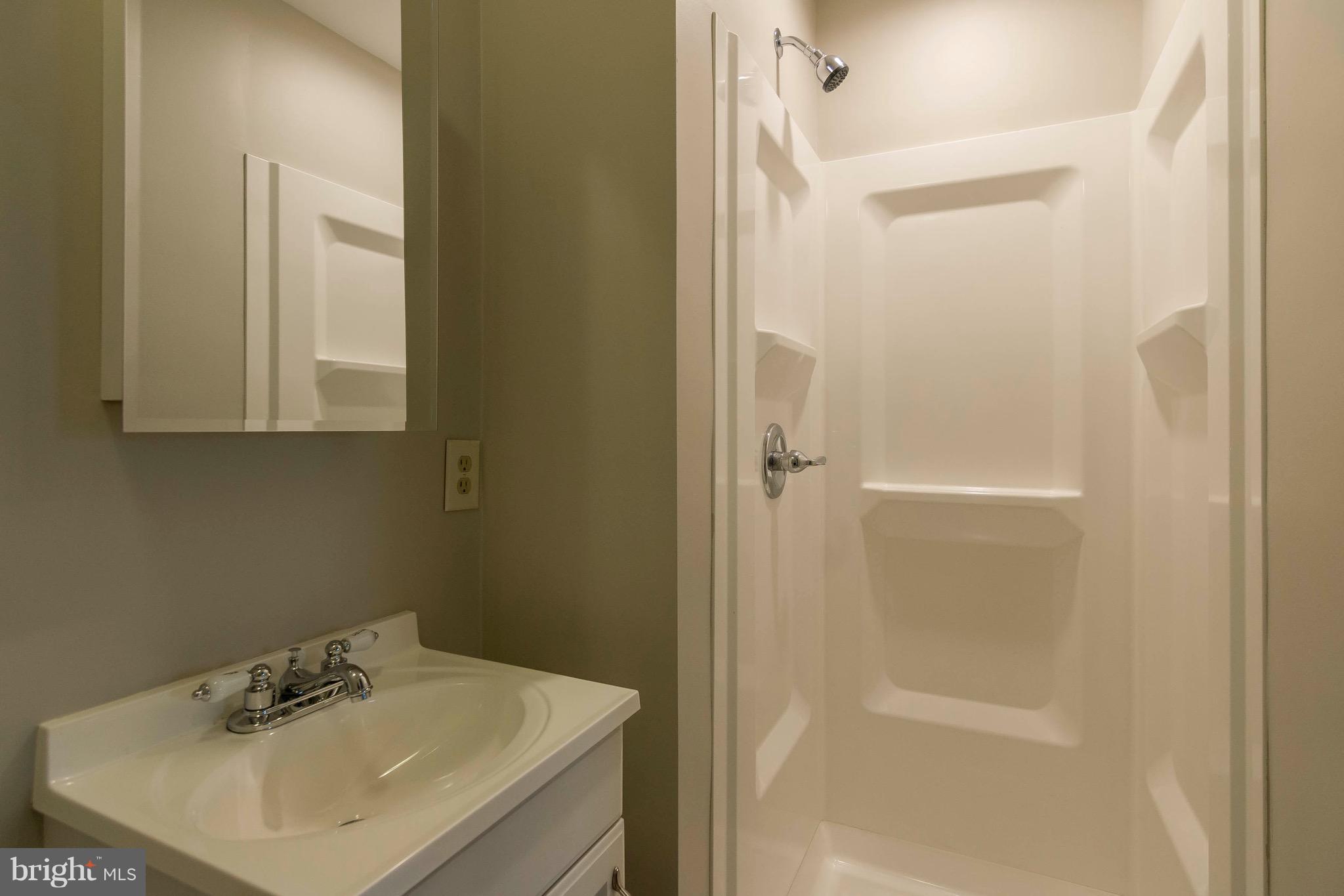 5901 Shady Spring Avenue Baltimore, MD 21237 - Photo 24 of 30 a bathroom with a sink toilet and shower