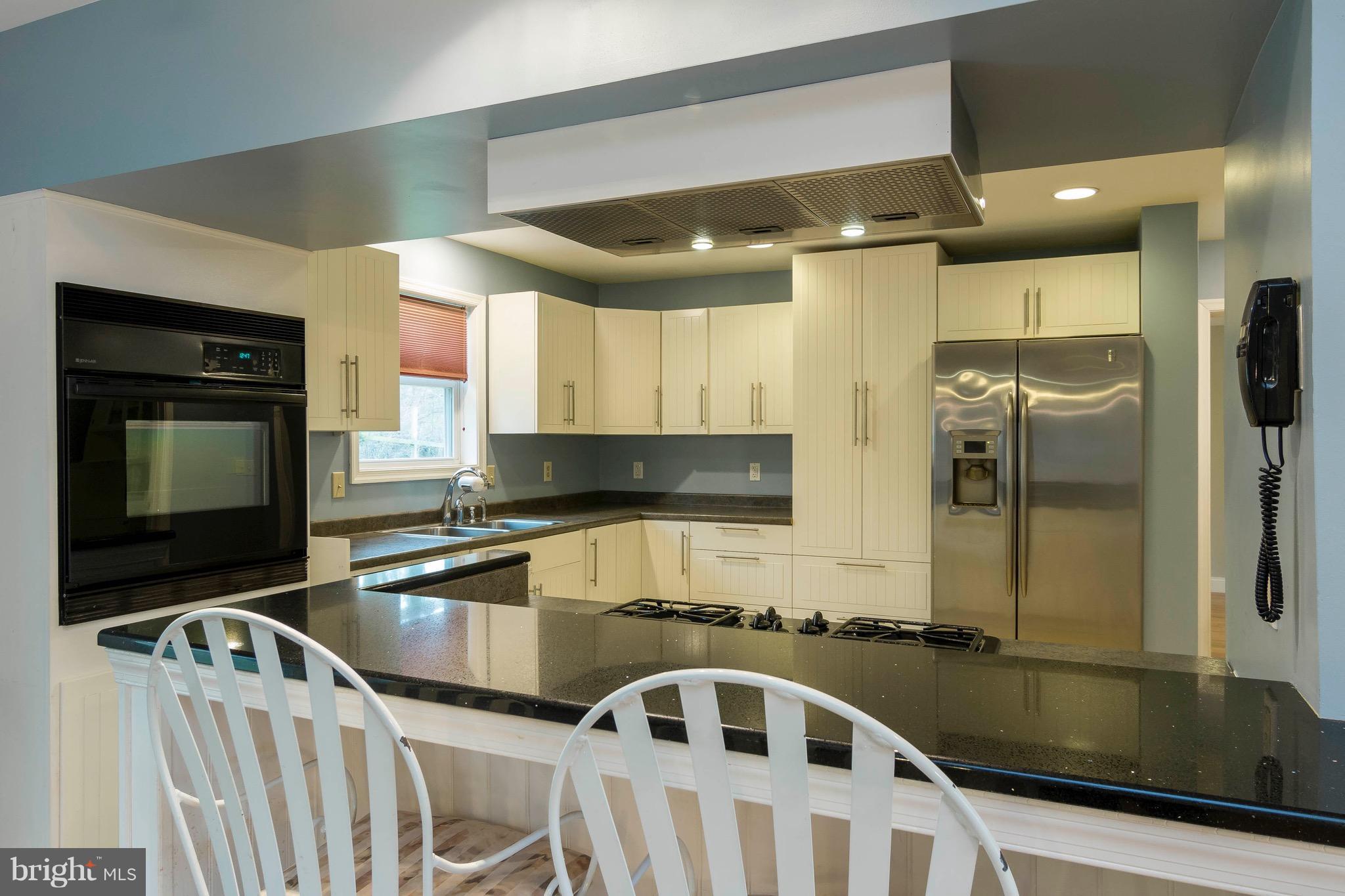 5901 Shady Spring Avenue Baltimore, MD 21237 - Photo 4 of 30 a kitchen with stainless steel appliances a sink a stove and a refrigerator