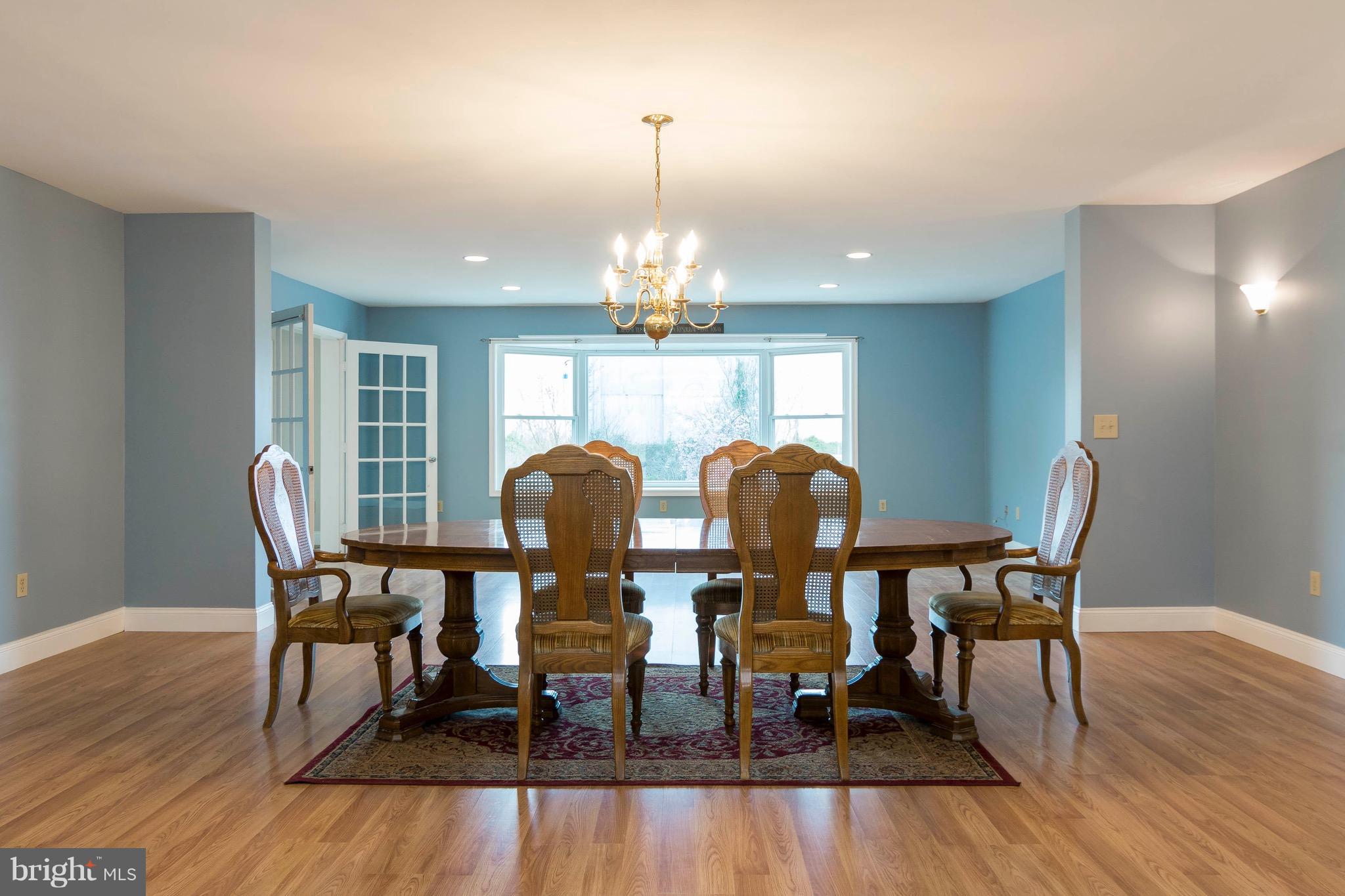 5901 Shady Spring Avenue Baltimore, MD 21237 - Photo 8 of 30 a view of a dining room with furniture and wooden floor