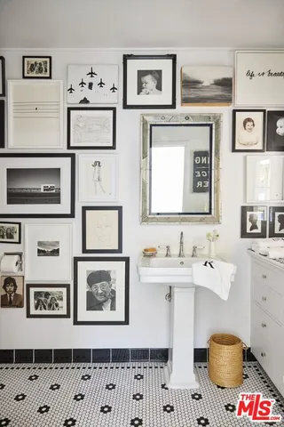 a spacious bedroom with a bed and a chandelier