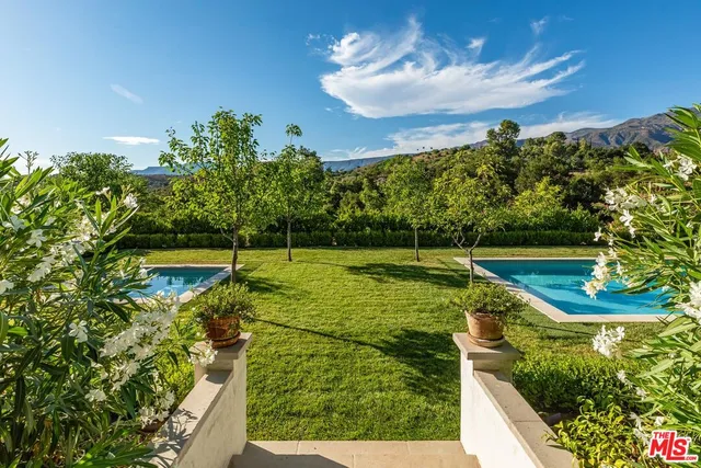 a view of a wooden deck with a big yard