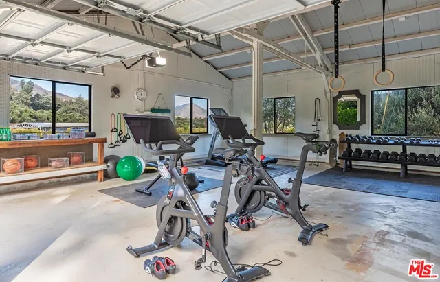 a view of a table and chairs under an umbrella