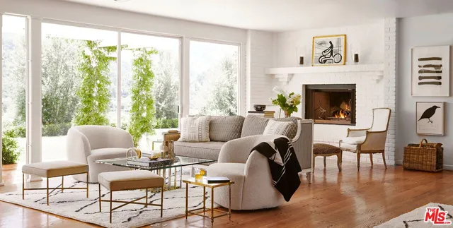 a living room with patio furniture and a garden