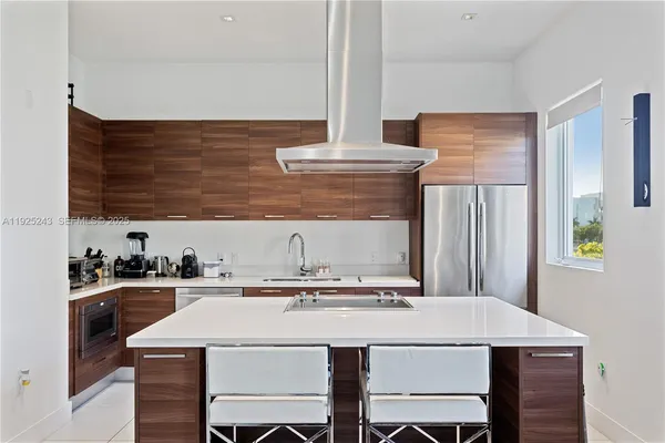 a kitchen with a stove a sink and a refrigerator