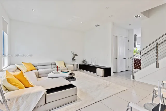 a living room with furniture and white walls