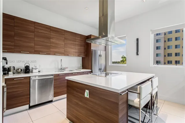 a kitchen with a sink cabinets and wooden floor