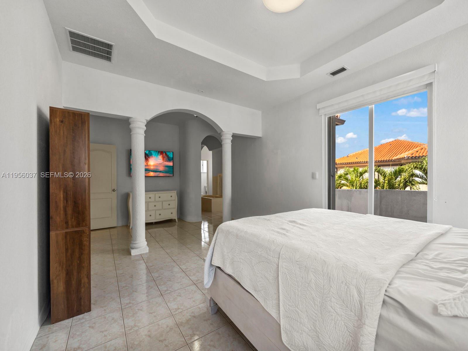 15383 Southwest 23rd Street Miami, FL 33185 - Photo 15 of 36 a bedroom with a bed and a painting on the wall