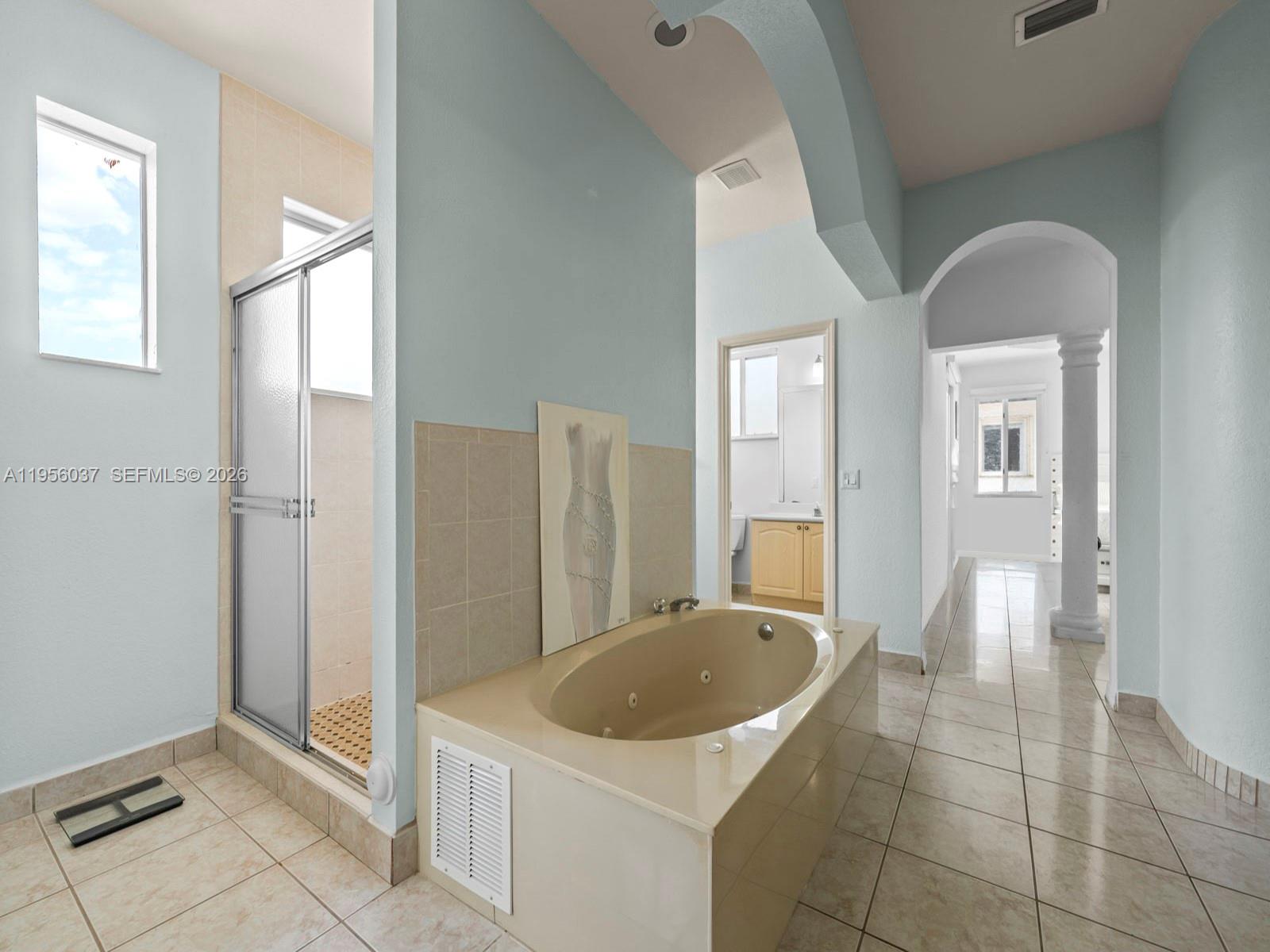 15383 Southwest 23rd Street Miami, FL 33185 - Photo 17 of 36 a bathroom with a sink a mirror and a bathtub