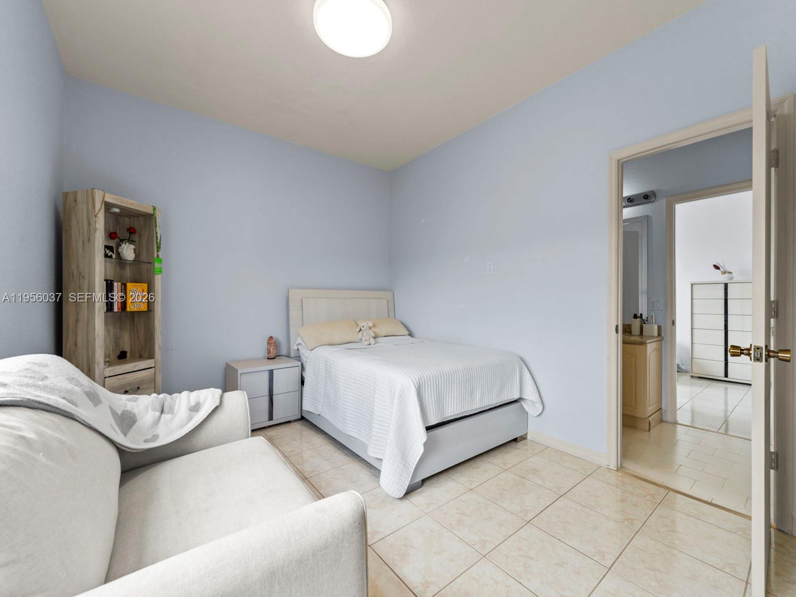 15383 Southwest 23rd Street Miami, FL 33185 - Photo 21 of 36 a bedroom with a bed and a couch