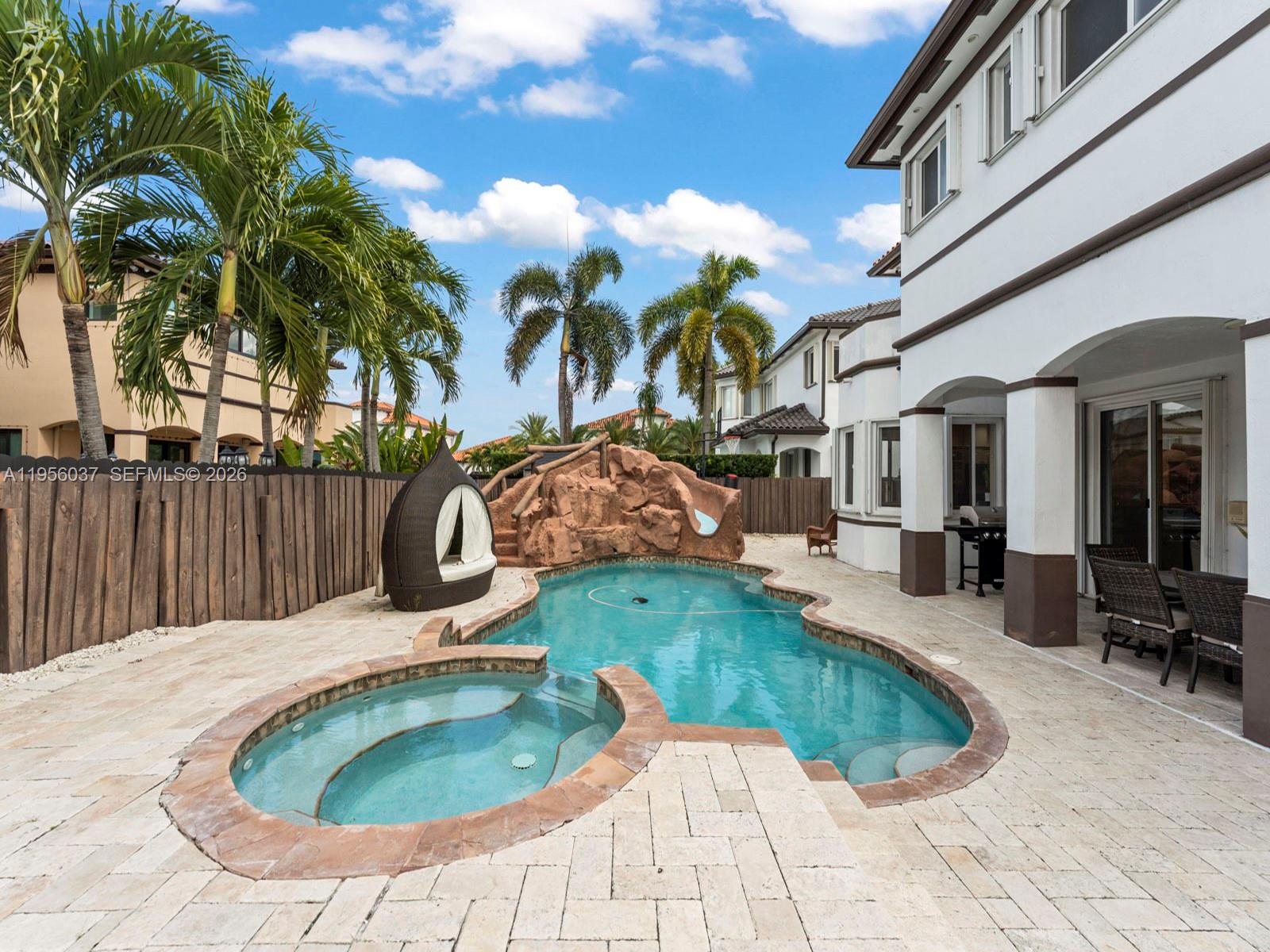 15383 Southwest 23rd Street Miami, FL 33185 - Photo 28 of 36 a view of a swimming pool with sitting area