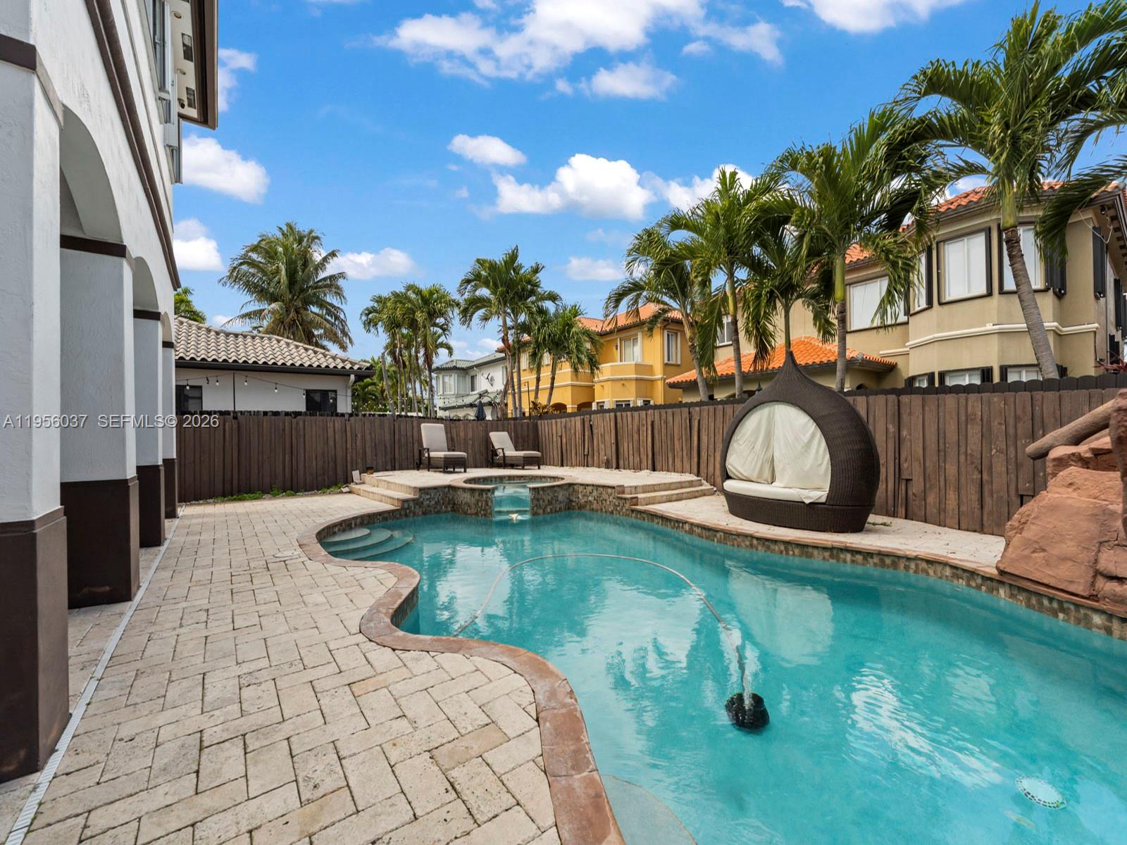 15383 Southwest 23rd Street Miami, FL 33185 - Photo 30 of 36 a swimming pool with outdoor seating and yard