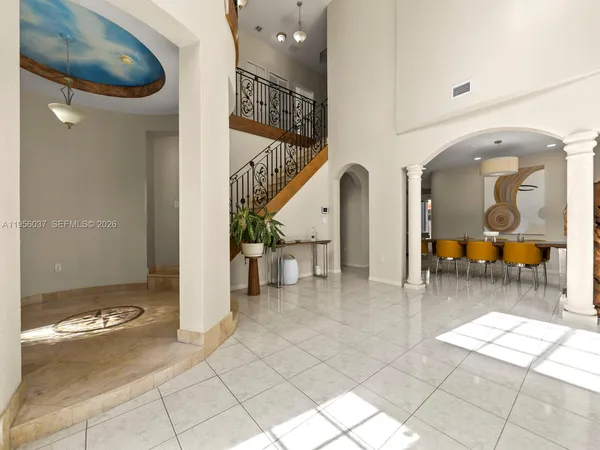 a living room with furniture and a painting on the wall
