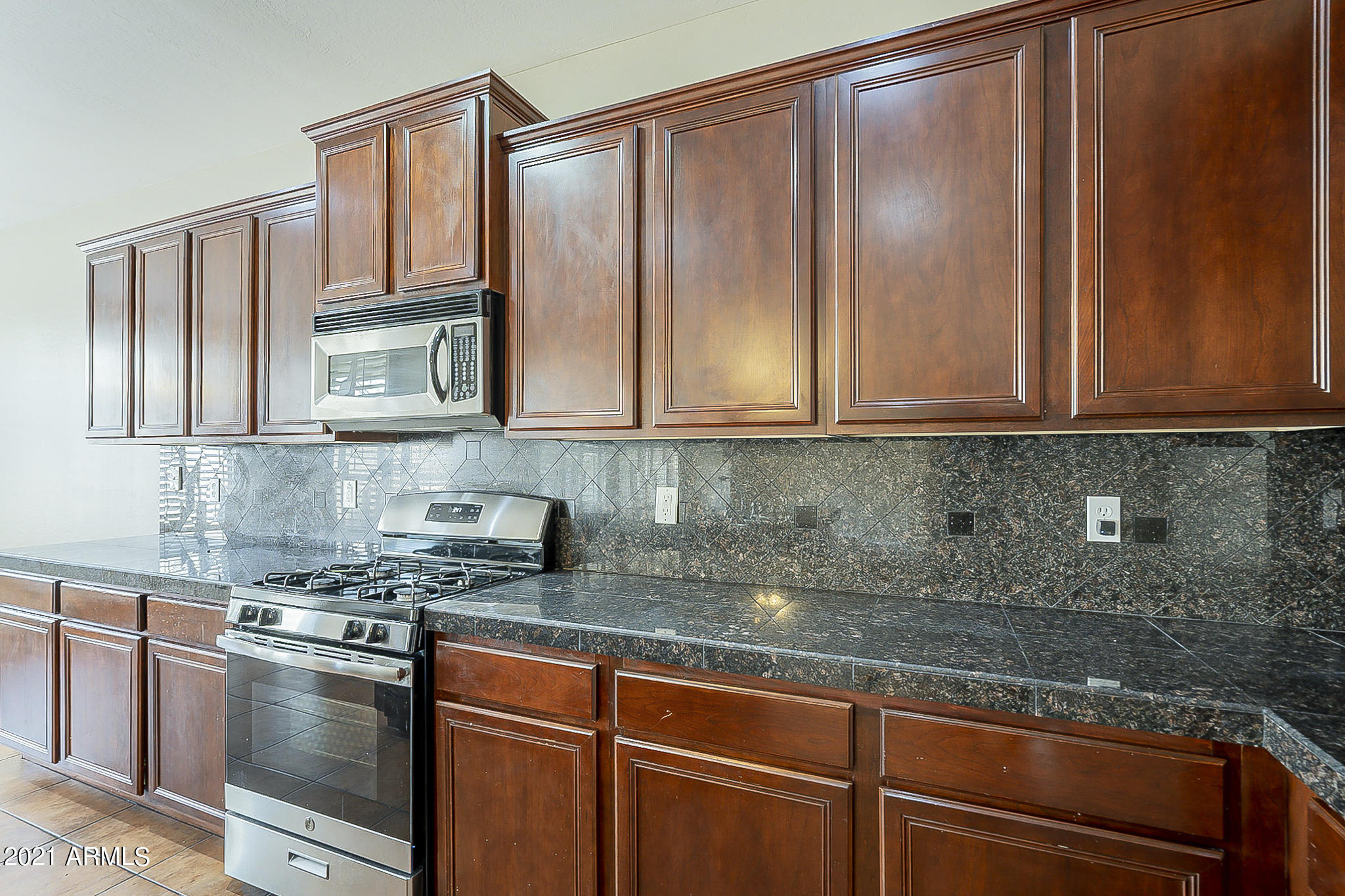 15346 West Boca Raton Road Surprise, AZ 85379 - Photo 20 of 45 a kitchen with stainless steel appliances granite countertop a sink a stove and cabinets