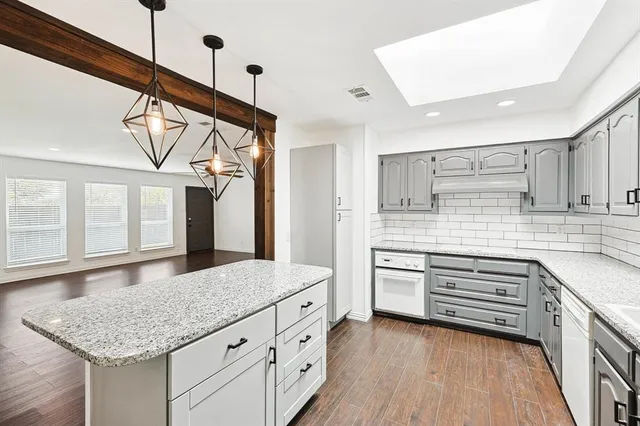a kitchen with stainless steel appliances granite countertop a sink and cabinets