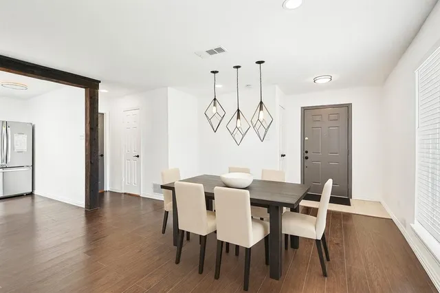 a view of a dining room with furniture wooden floor and chandelier