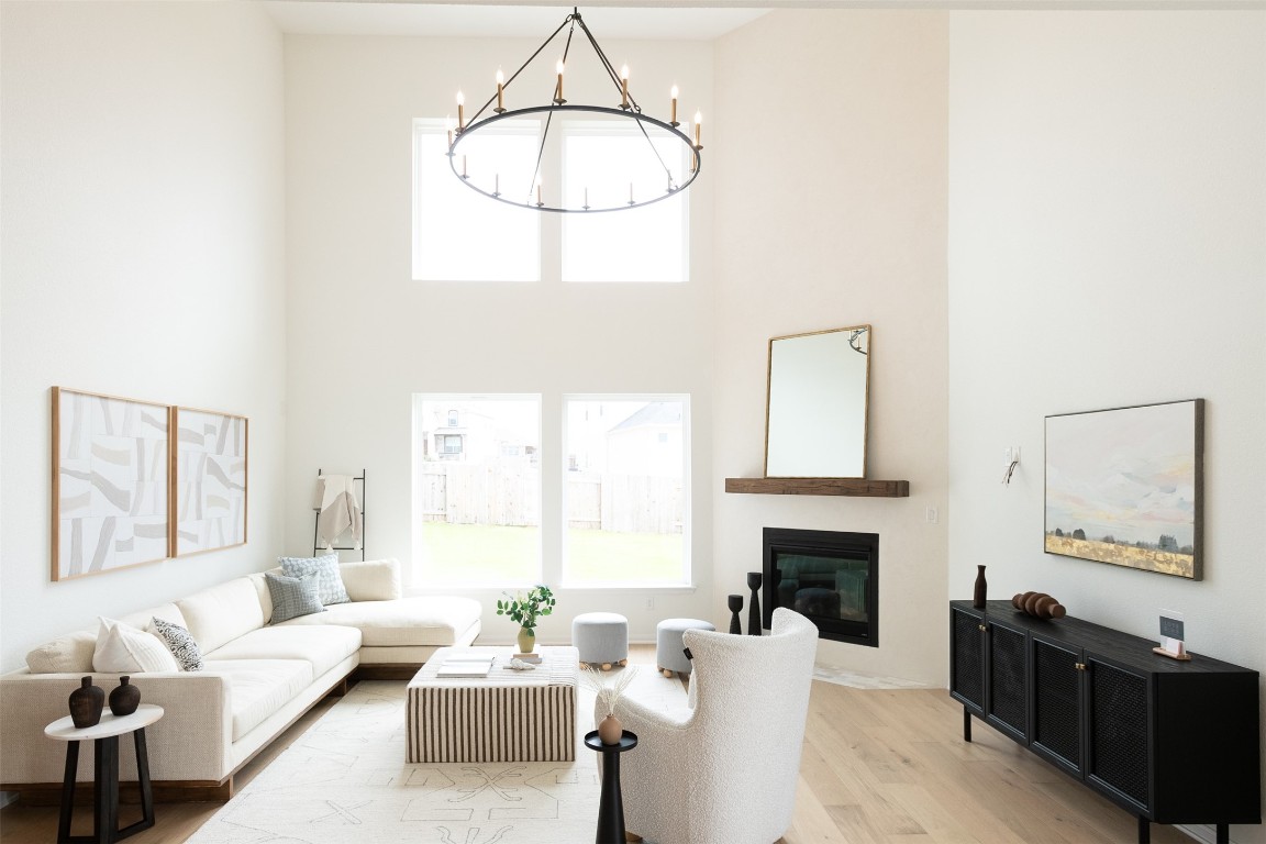 a living room with furniture a fireplace and a large window