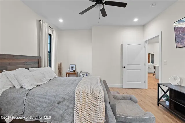 a bathroom with a double vanity sink a toilet a mirror and shower