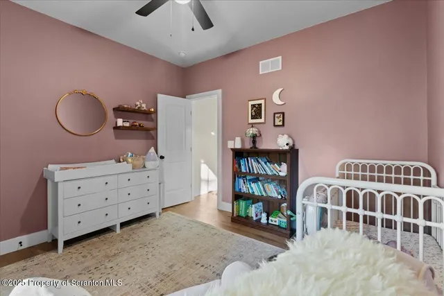 a view of a workspace with furniture and a bookshelf