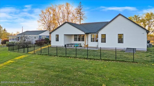 a view of a house with a yard and porch