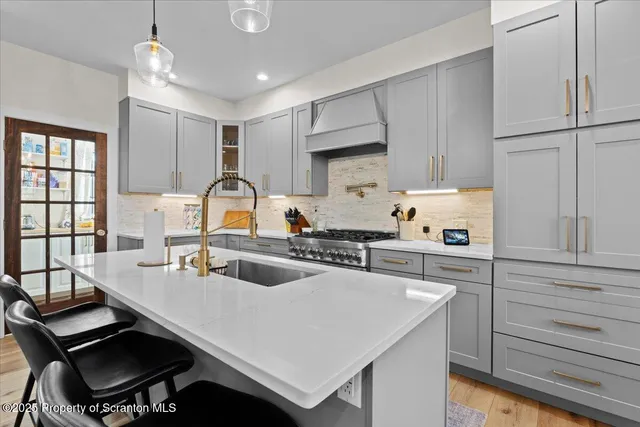 a kitchen with a sink a stove a refrigerator and cabinets