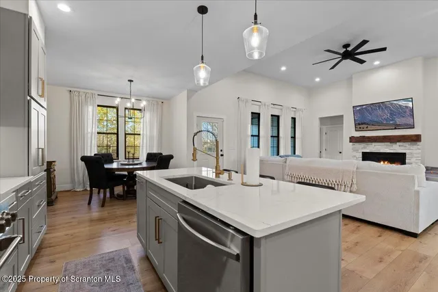 a view of a hallway with wooden floor and workspace
