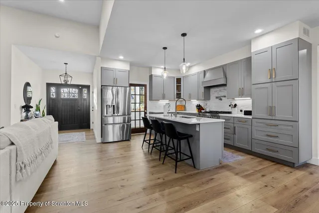 a kitchen with cabinets and a wooden floor