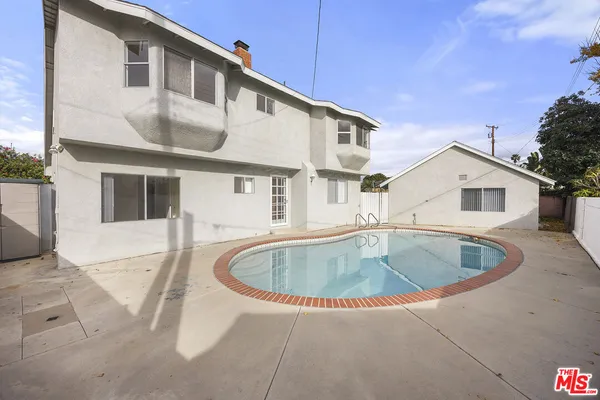 a view of a white house with swimming pool
